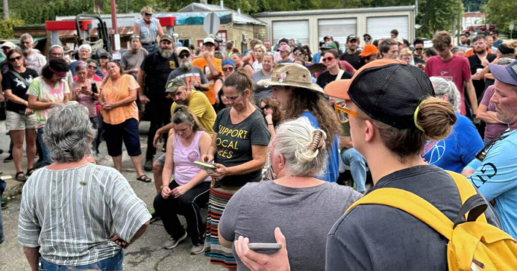 Community members gather out front of Sara Jo's Station following Hurricane Helene